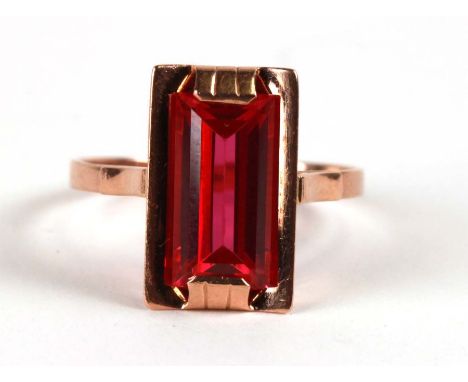 A 14ct gold cocktail ring with emerald cut synthetic ruby, approx UK size 'V'.