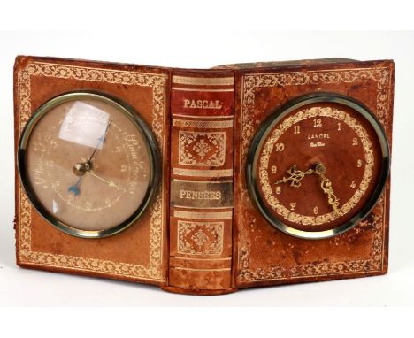 A desk clock barometer mounted in an open book stand, 24cms wide.