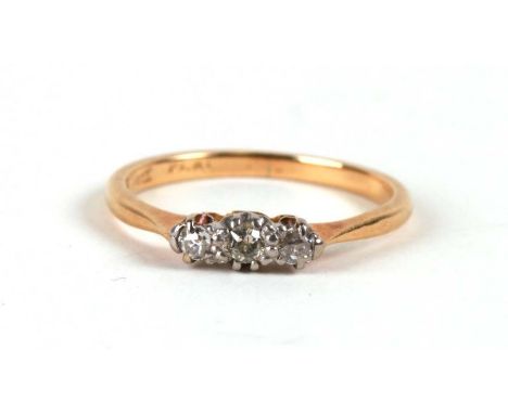 An 18ct gold and platinum three-stone diamond ring, approx UK size 'M'.