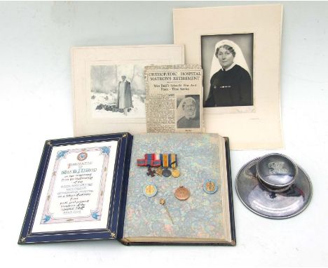 A WWI miniature medal group awarded to Miss Beatrice J D Reid who was a nurse during WWI, her 9ct gold locket, Queen Alexande