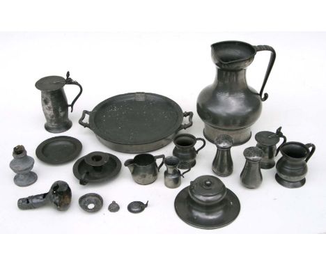 A quantity of assorted pewter items to include a jug, 22cms high, an inkwell, 13cms diameter; a chamberstick and other items.