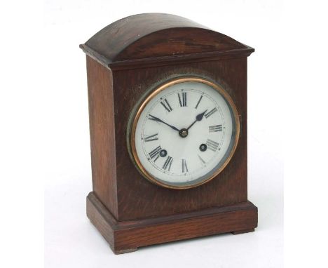 An Edwardian oak cased mantle clock, the white dial with Roman numerals, 29cms high.