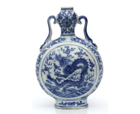 A Chinese blue &amp; white moon flask decorated with dragons amongst clouds chasing a flaming pearl, blue seal mark to the un