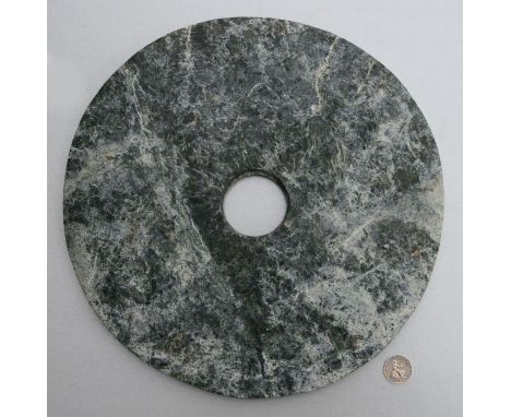 A large Chinese figured greenstone Neolithic style disc, 37cms diameter.Condition ReportGood condition