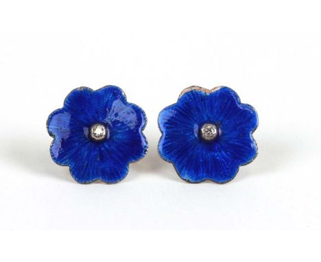 A pair of silver enamel and diamond set flower shaped stud earrings.