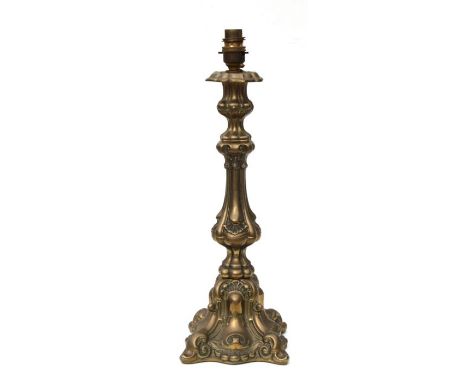 A brass rococo design table lamp, 39cms high.