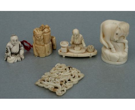 A Chinese ivory netsuke in the form of a seated man; together with similar netsuke and okimono (5).