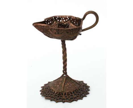 A Persian influenced copper candlestick decorated with scrolling flowers, 18cms high.