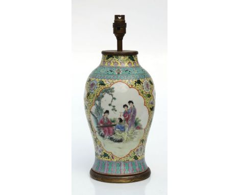 A Chinese Canton famille rose baluster vase converted to a table lamp with panels decorated with figures, 30cms high.