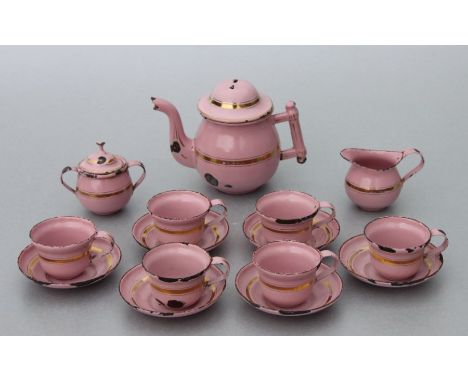 A vintage pink enamel and gilt doll's tea set.