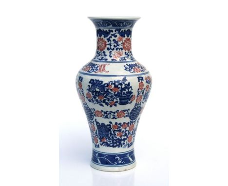 A Chinese underglaze blue, white and red vase decorated with fish, foliate scrolls and symbols, blue seal mark to the undersi