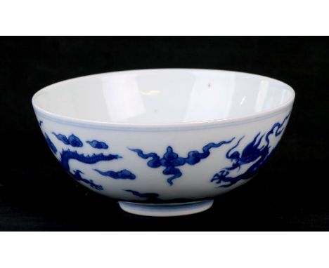 A 19th century Chinese blue &amp; white bowl decorated with dragons amongst clouds, Qianlong seal mark to the underside, 13cm