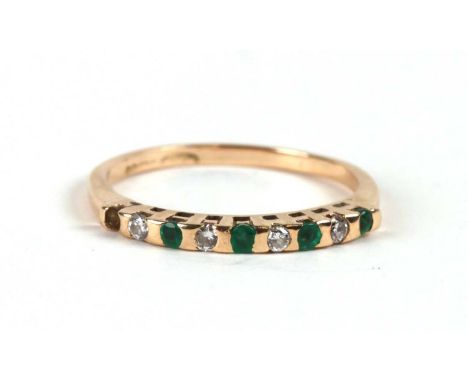 A 9ct gold diamond and emerald half hoop ring, approx UK size 'M'.