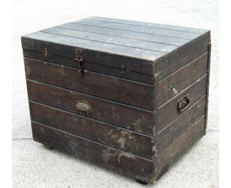 A pine trunk with iron carrying handles, 74cms wide.