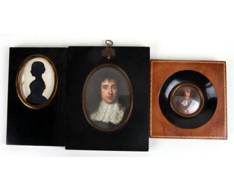 A three quarter length silhouette depicting a young lady in an ebonised frame; together with two portrait miniature prints (3