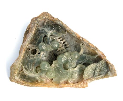 A Chinese green stone boulder carving depicting carp in a pond, 22cms wide.