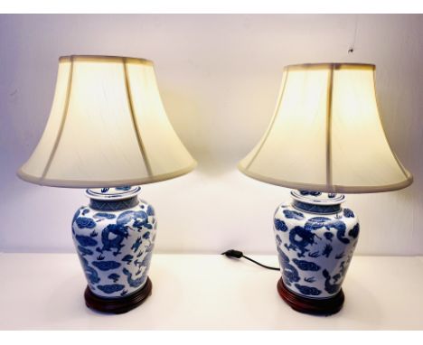 TABLE LAMPS, a pair, 61cm high, Chinese export style blue and white ceramic, with shades. (2) 