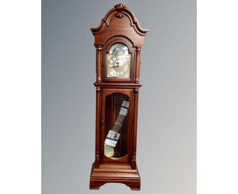 A contemporary longcase clock with moon phase dial, pendulum and weights.