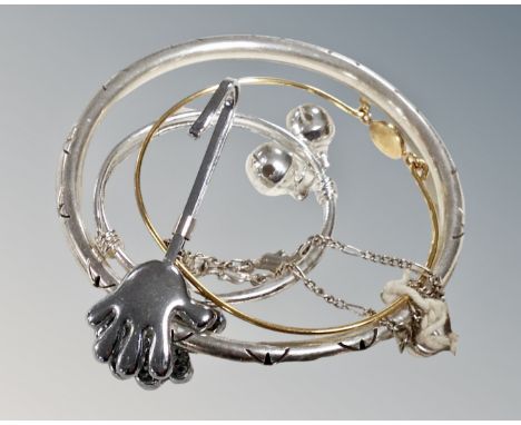 A Mexico 925 silver bangle, a silver dolphin bracelet, a yellow metal bangle with blue stone and a silver bracelet with bells