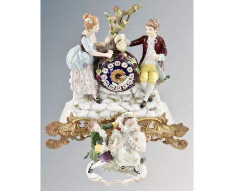 A continental ceramic and gilt metal figural mantel clock together with a further figure group.