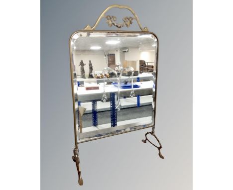 A brass framed Art Nouveau mirrored fire screen.