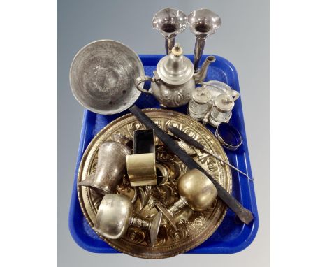 A tray containing antique and later metal wares including cast iron handled ladle, brass plaque, goblets, cruet set, plated v