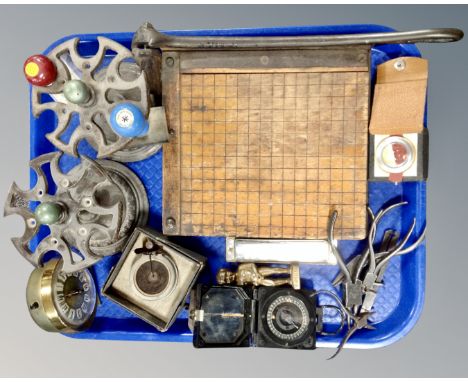 A tray containing a pair of cast iron stands, vintage hand tools, a pocket compass, brass figure, a gramophone sound box, vin