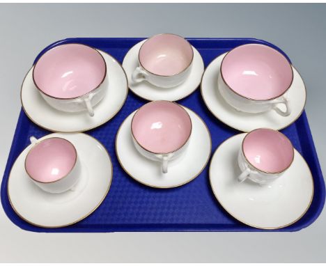 A tray of three pairs of vintage china two-tone teacups and saucers 
