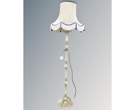A gilt and onyx standard lamp with shade.
