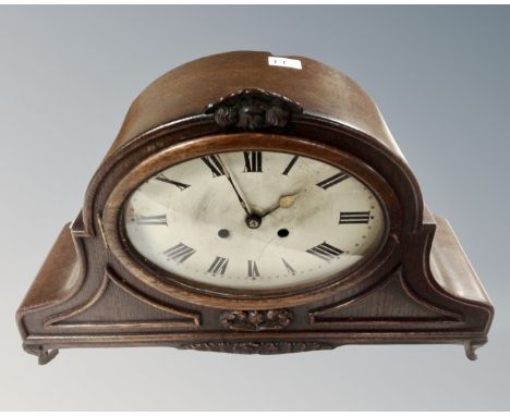 A large oak cased eight day mantel clock with silvered dial, width 49 cm