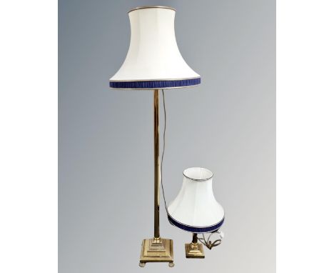 A brass floor lamp on paw feet with shade, together with a further brass Corinthian column table lamp with shade.