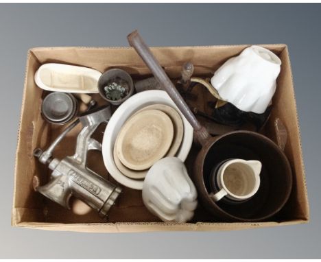 A box of kitchenalia to include 19th century cast iron handled pan, mincer, ceramic jelly moulds, blue and white jug etc 