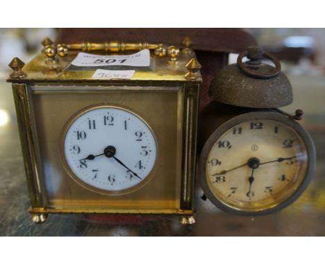 A leather cased brass bound square section carriage clock together with a circular faced alarm clock (2). 