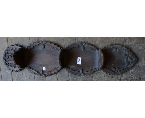 An early 20th Century carved oak hanging shelf, having acorn carved decoration.