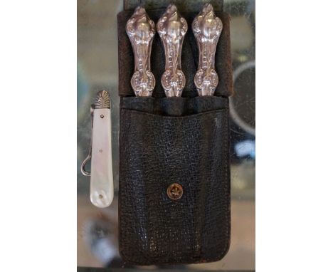 A Birmingham hallmarked silver handled manicure set, set with leather pouch together with a mother of pearl handled button ho