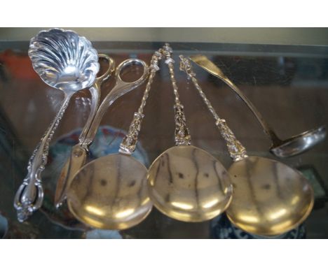 A mixed group of hallmarked silver and white metal cutlery to include grape scissors and sauce ladle (6).  