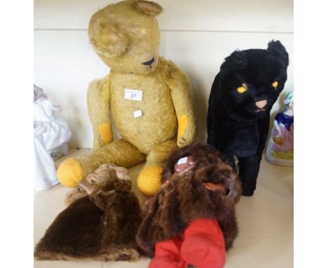 A vintage gold plush teddy bear together with a monkey glove puppet, a plush cat etc.