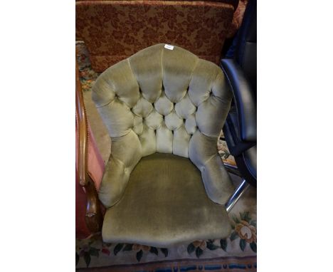 A Victorian button back nursing chair upholstered in green material.