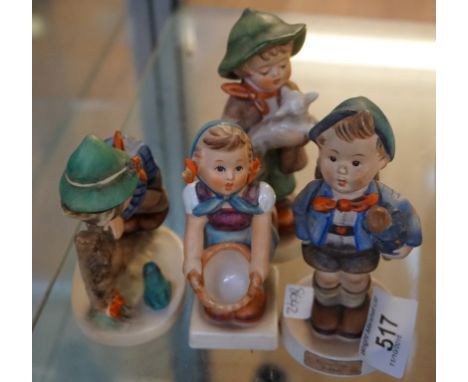 A collection of four Goebel Hummel figures to include a boy holding an umbrella and a girl holding a basket.
