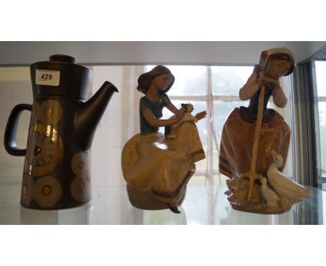 A mixed group of ceramic items a Lladro figurine of a girl and two ducks and a Lladro girl holding a cat, together with a cof
