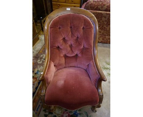 A Victorian sherwood framed nursing chair upholstered in a pink button back material.