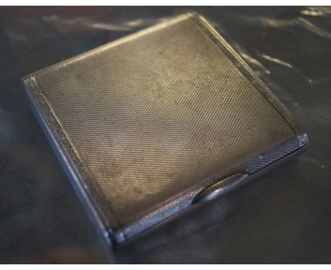 A Birmingham hallmarked silver Art Deco engine turned compact. 