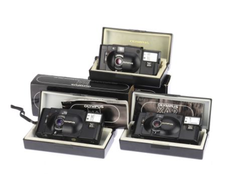 Three Olympus XA Series 35mm Compact Cameras, to include an Olympus XA, body F, rangefinder patch F, shutter working, needle 