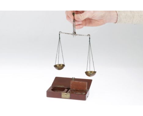 Small Set of Scales, English, mid 19th Century, unsigned, steel beam with brass pans, in mahogany case with small weights in 