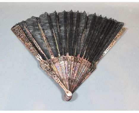 A Late 19th Century French Lace Fan, mother of pearl sticks with foliate carving, black Chantilly lace leaf with foliate bouq
