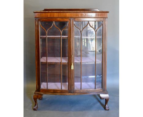 An Early 20th Century Mahogany Bow-Fronted Display Cabinet with a low galleried back above two astragal glazed doors enclosin