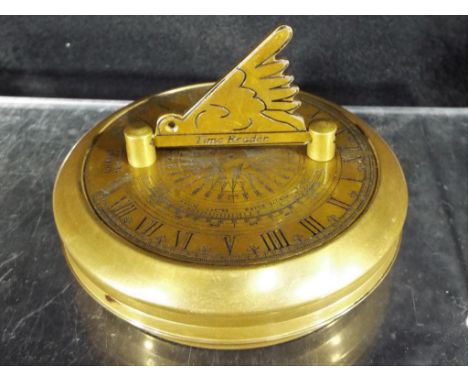 A portable brass sundial / compass scribed 'Gilbert' approx 7.7 cm (diameter) This lot must be paid for and collected (or des