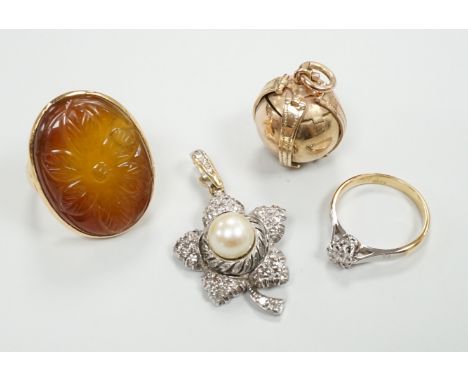 A 9ct masonic ball pendant, 18mm, a 750 white metal cultured pearl and diamond chip set flower head pendant, 38mm, a yellow m