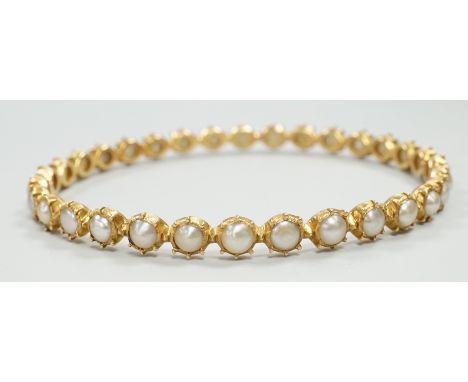 A modern yellow metal and split pearl set bangle, interior diameter approx. 58mm, gross weight 13.7 grams.