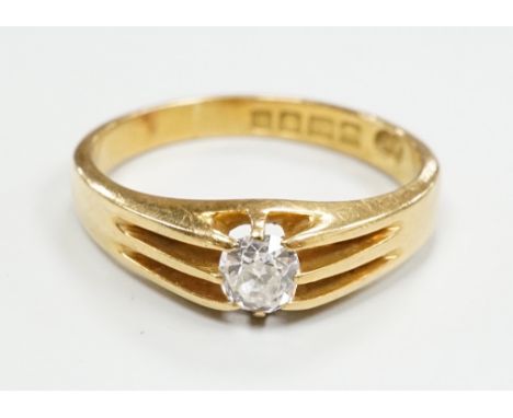 A George V 18ct gold and claw set solitaire diamond ring, size R, gross weight 5.1 grams.